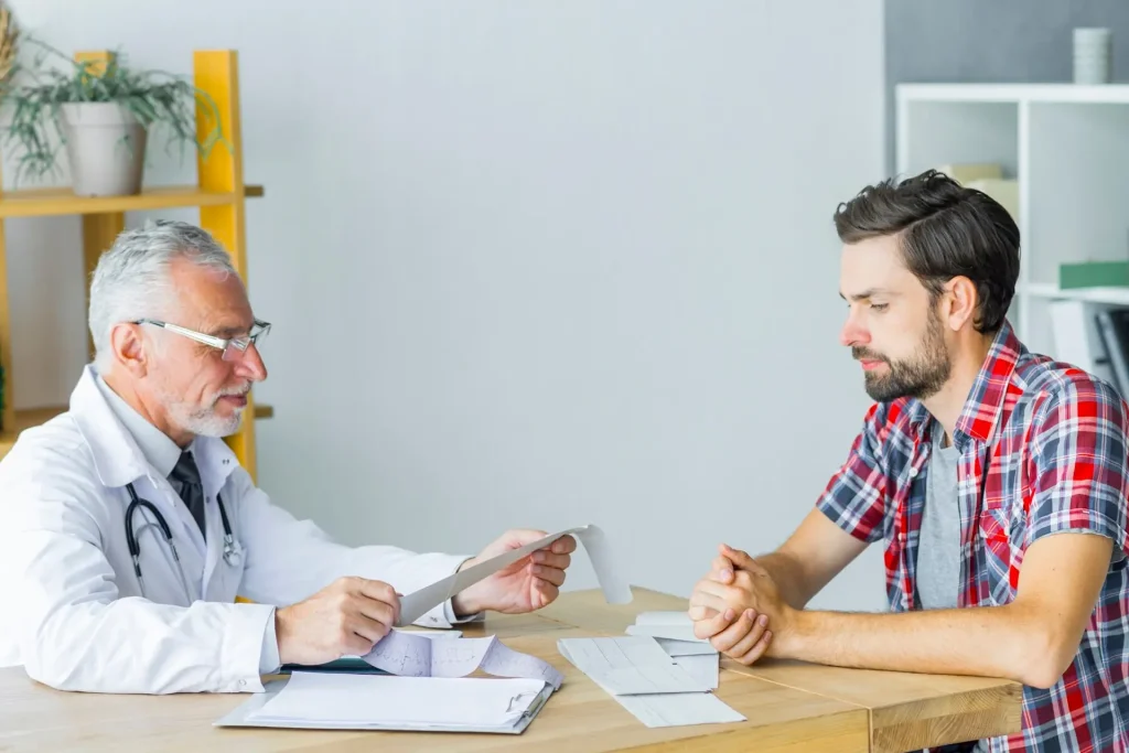 Doctor consulting patient about erectile dysfunction diagnosis and treatment in Birmingham clinic