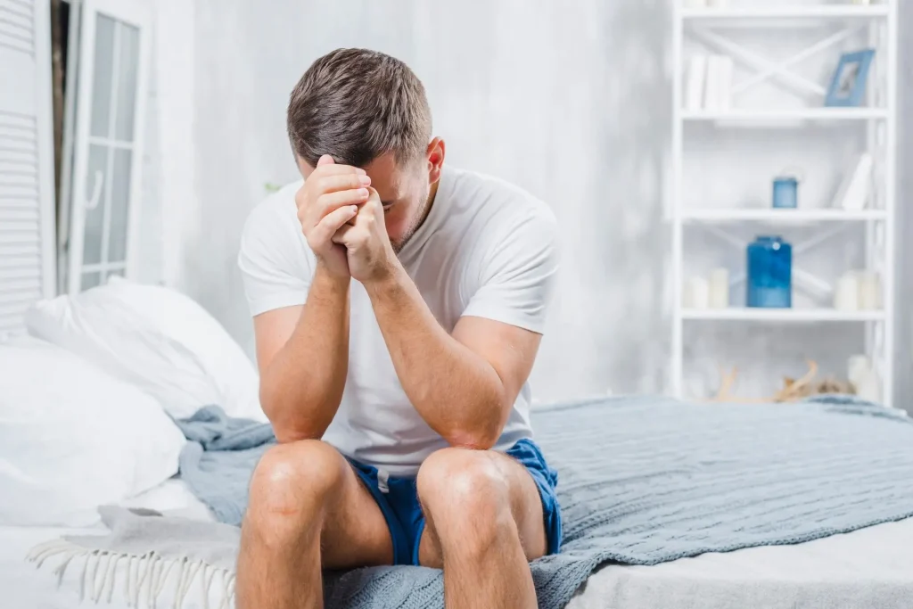 Man experiencing stress related to male infertility symptoms in Birmingham