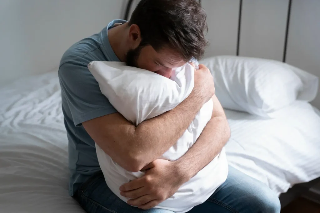 Man experiencing discomfort and distress related to Peyronie’s disease symptoms in Birmingham