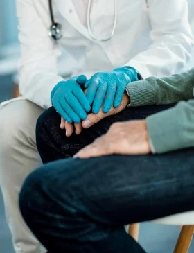 Doctor providing supportive urology treatment consultation to a patient in a clinical setting